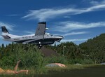 Grand Caravan po vzlete zo slnkom zaliateho Lake Sulivan strip. Grand Caravan po vzlete zo slnkom zaliateho Lake Sulivan strip.